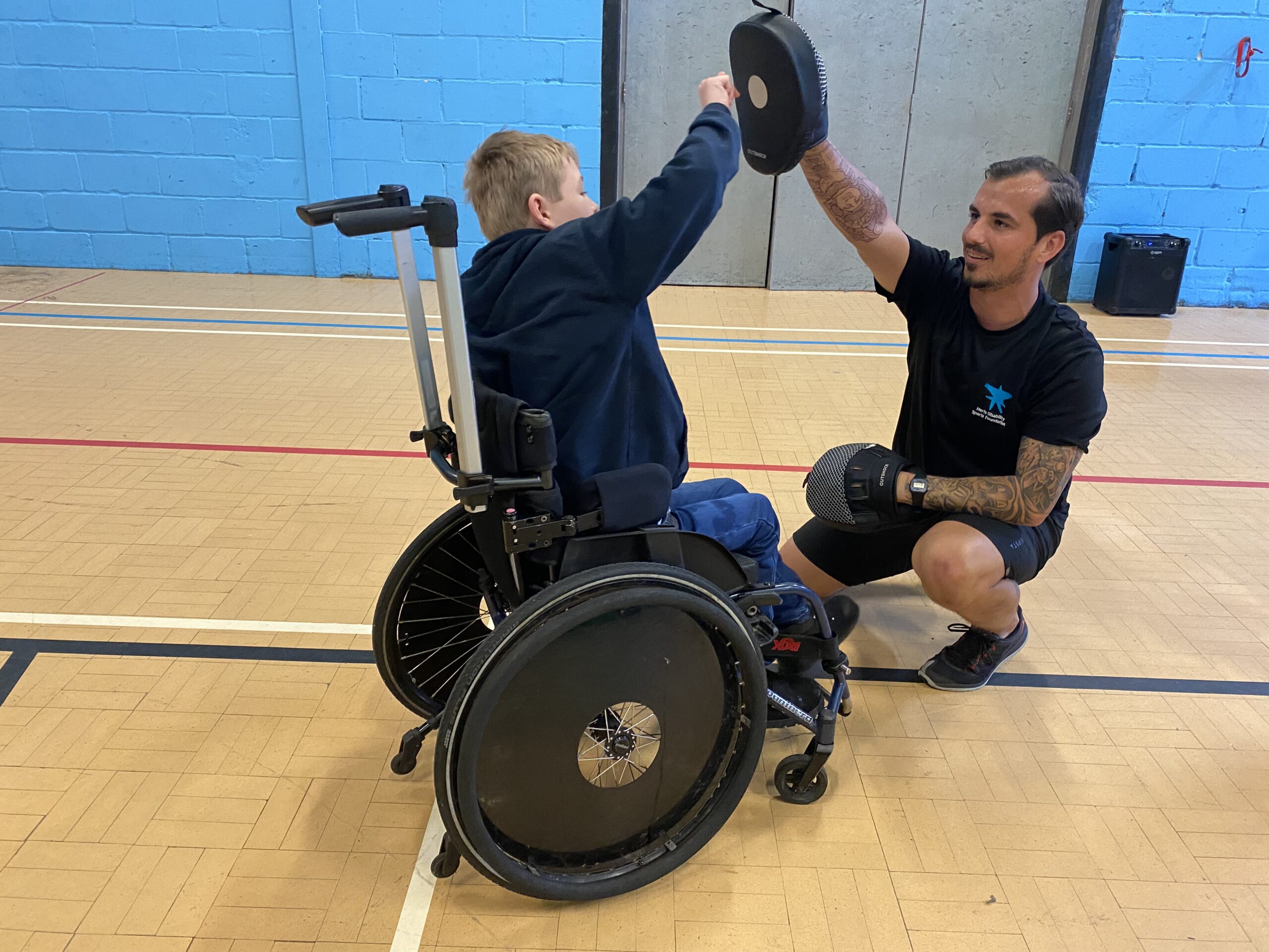 Charlie working with a young man in a boxercise session